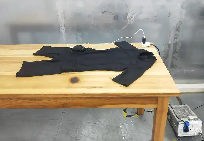 Professional EMS suit laid out and connected during setup before a targeted muscle stimulation session